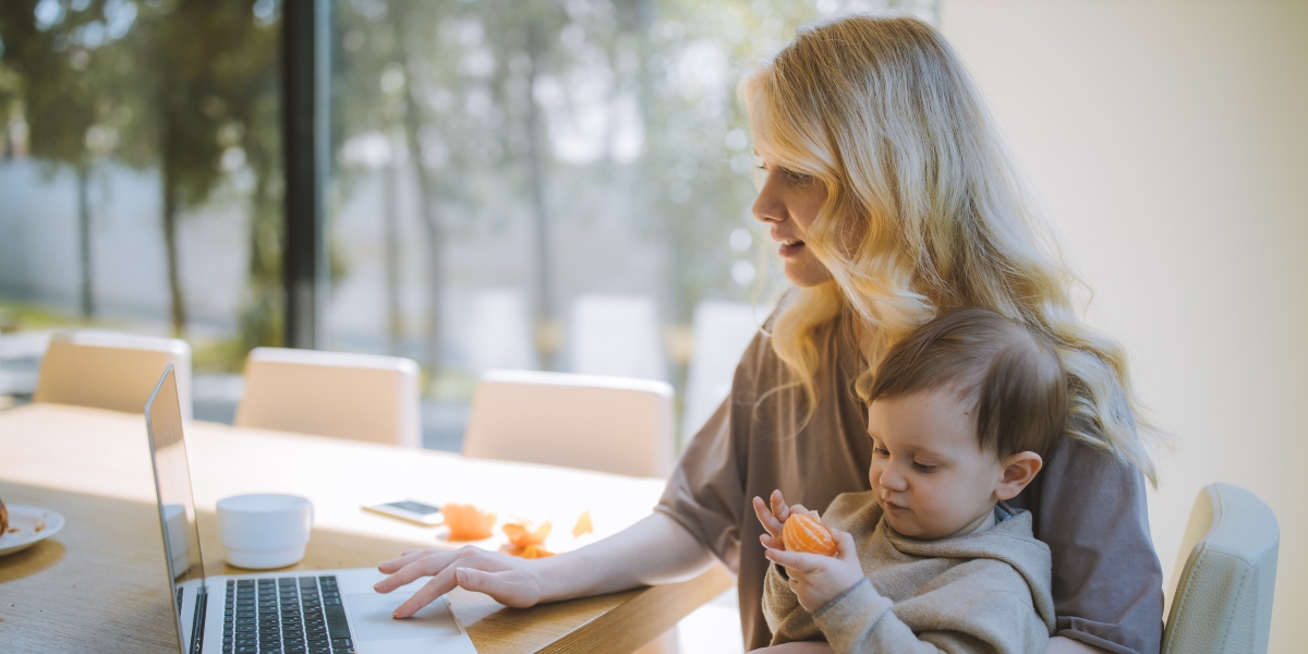 Woman Working From Home With a Child